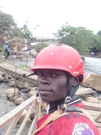 Budalah, river guide, in his red helmet above the rapids at Jinja